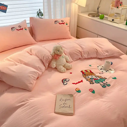 Pastel pink cartoon embroidered cotton bedding set with cute girl and colorful floral rainbow accents by decorbites