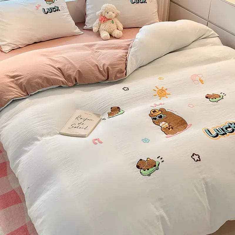 White duvet cover with embroidered brown bear characters and luck text in pastel cartoon embroidered cotton bedding set