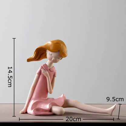 Pink resin cartoon girl sculpture with flowing orange hair sitting contemplatively for bedroom desk decorbites decor