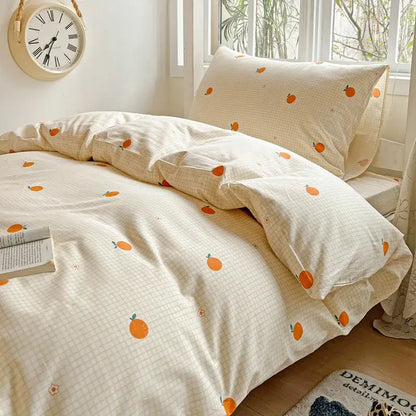 Cream-colored cotton bedding set with subtle grid pattern and orange fruit prints from decorbites cotton grid collection