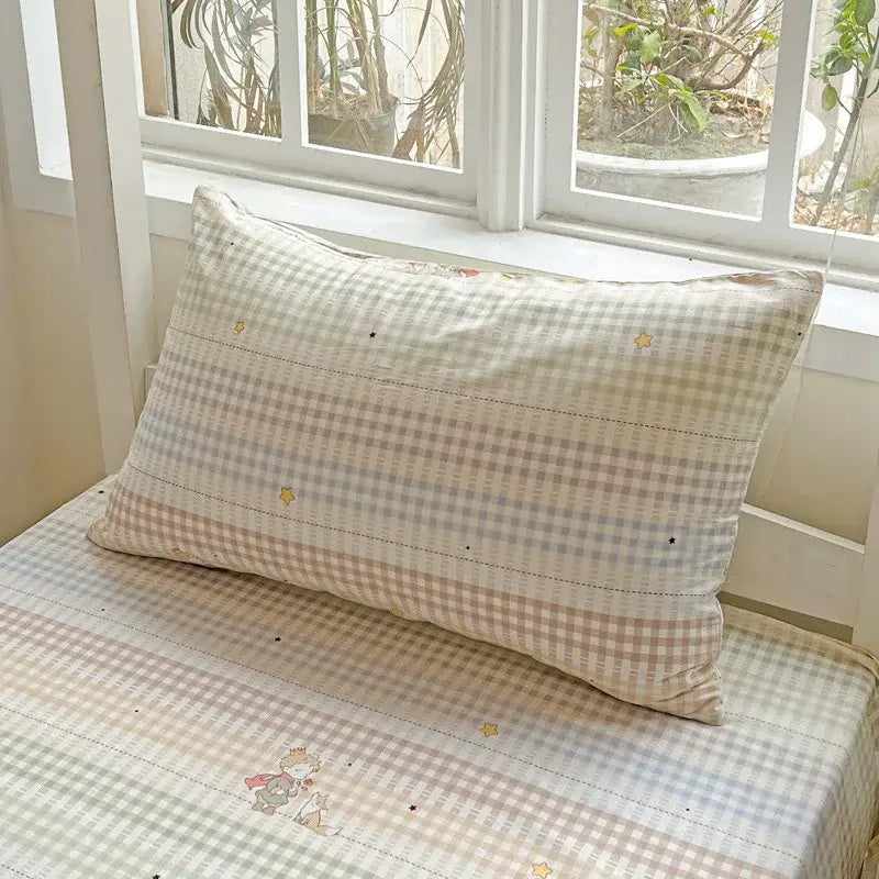 A cream-colored pastel checkered cotton grid pattern pillow with embroidered stars from decorbites bedding set