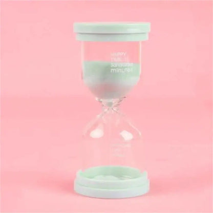 A mint green plastic-capped glass hourglass sand timer with clear body and printed text for kids bedroom decorbites hourglass sand