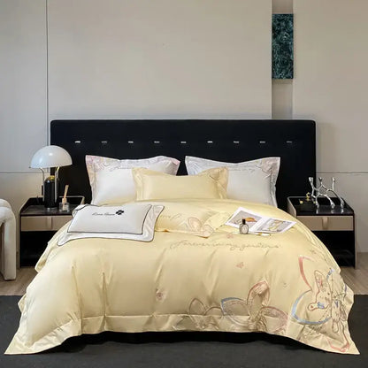 Cream-colored satin bedding set with delicate embroidered butterfly flowers and gold thread accents by decorbites
