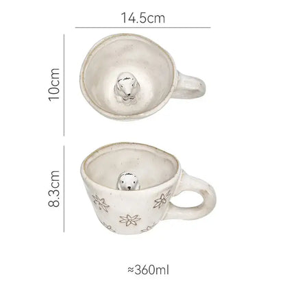 White ceramic cartoon animal coffee mug with pastel floral patterns and a small seal figurine by decorbites 3d cartoon