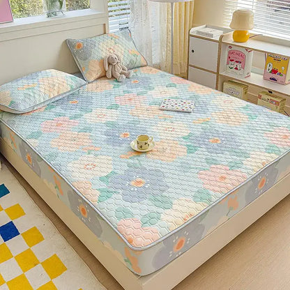 Pastel floral quilted latex fitted sheet set with hexagonal stitching in soft blue pink and green tones bedroom bed pad