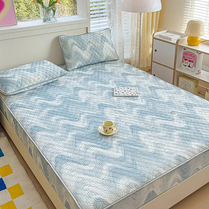 Light blue quilted latex fitted sheet set with subtle hexagonal pattern and matching pillow for bedroom use