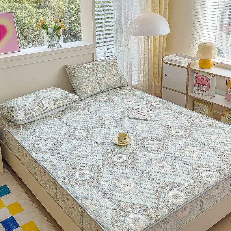 Light blue quilted latex fitted sheet set with delicate gray and white floral pattern for bedroom use