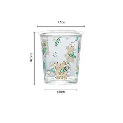 Clear glass bear rabbit glass tea cup with beige teddy bears holding daisies and subtle glitter accents for coffee use