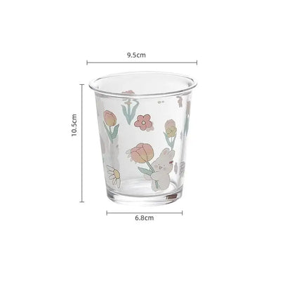 Clear glass tea coffee cup with pastel floral rabbit design featuring a white bunny holding tulips for kitchen use