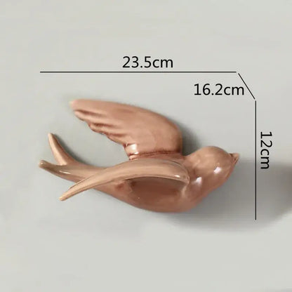 Glossy rose gold ceramic flying bird wall ornament with detailed wings and smooth sculpted body for living room decor