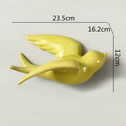 Glossy yellow ceramic flying bird wall ornament with smooth curved wings for living room decor