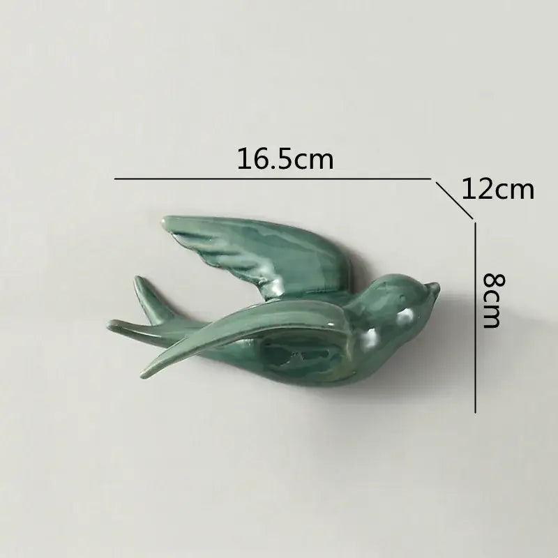 A sleek glazed green flying bird ceramic wall ornament with detailed wings for living room decor