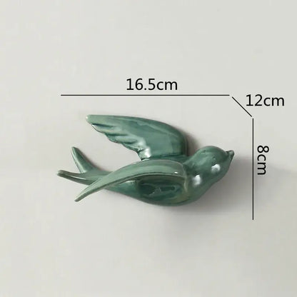 A sleek glazed green flying bird ceramic wall ornament with detailed wings for living room decor