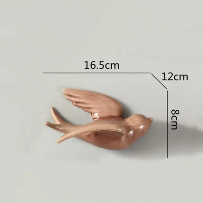 A sleek rose-gold ceramic flying bird wall ornament with smooth glossy finish and detailed wing contours for living room decor