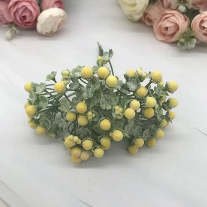 A cluster of pastel yellow foam ball artificial berries with frosty green leaves for living room decorbites decorbites foam ball