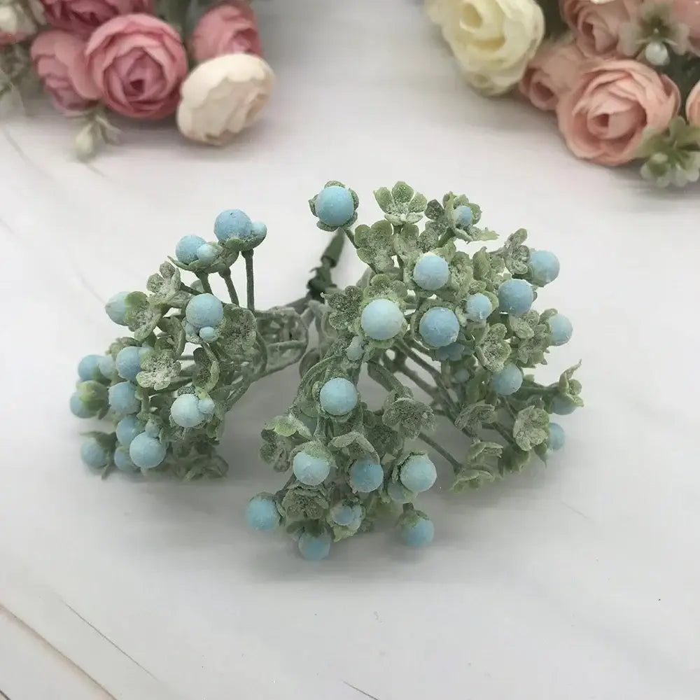 A cluster of pastel foam ball artificial flowers with light blue berries and frosted green leaves for living room decorbites decor
