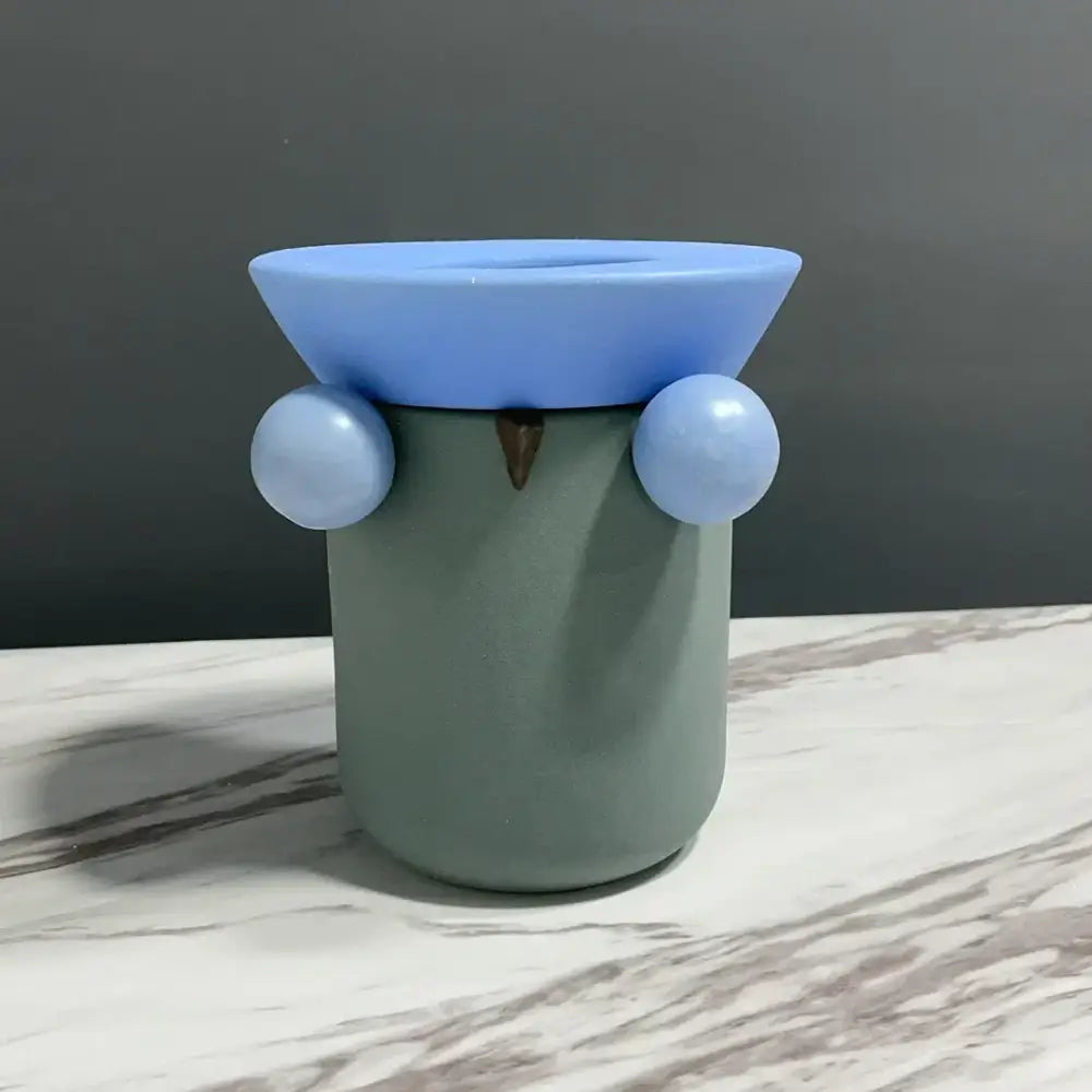 A mint green ceramic geometric ball owl tissue box with light blue eyes and matching lid for decorbites geometric ball decor