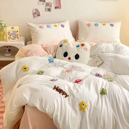 White plush cat-shaped pillow with colorful embroidered eyes and nose in pastel green cartoon embroidery bedding set decorbites