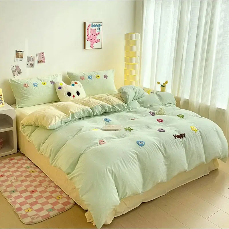Pastel green quilted bedding set with colorful cartoon towel embroidery and happy stitched decorbites cartoon towel design