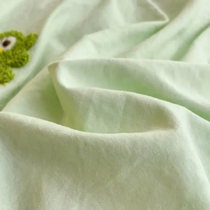 Pastel green bedding set with soft mint fabric and cartoon towel embroidery featuring a green frog decorbites design