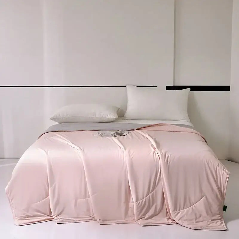 A soft blush-pink satin duvet cover with subtle sheen and folds complementing decorbites green summer cooling comforter
