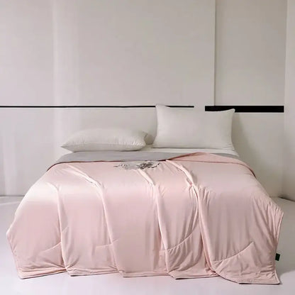 A soft blush-pink satin duvet cover with subtle sheen and folds complementing decorbites green summer cooling comforter