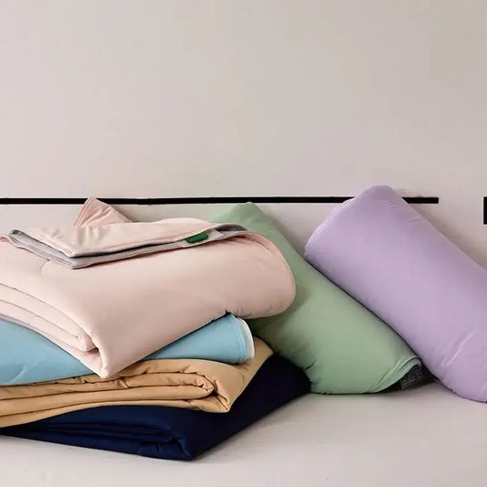 Stack of pastel-colored quilted comforters including decorbites green summer cooling comforter for bedroom bedding