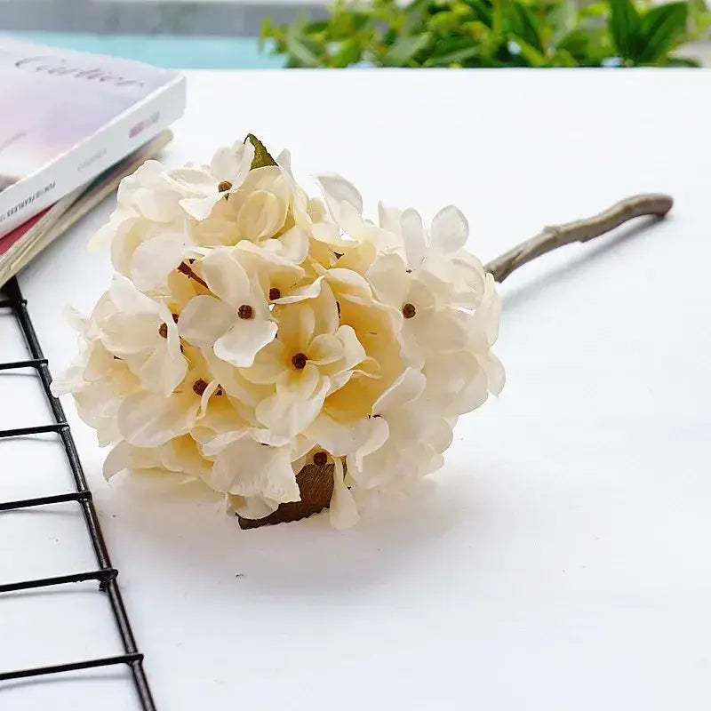 Cream-colored decorbites hydrangea branch silk flower bouquet with delicate petals and rustic wooden stem for dining room decor