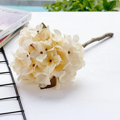 Cream-colored decorbites hydrangea branch silk flower bouquet with delicate petals and rustic wooden stem for dining room decor