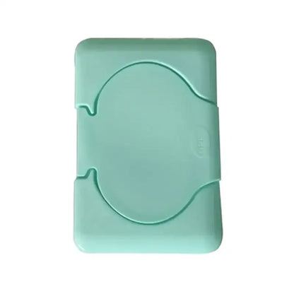 A pastel mint green plastic baby wet wipes dispenser with a rounded shape and circular cutout for easy access