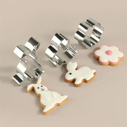 Set of shiny silver stainless steel easter cookie cutter set with pastel painted matching frosted easter cookies