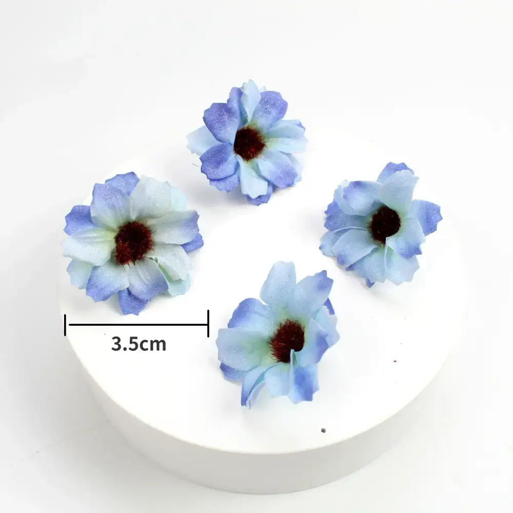 Pastel pink and lavender decorbites mini daisy artificial flowers with light blue fabric petals and dark red centers for decor
