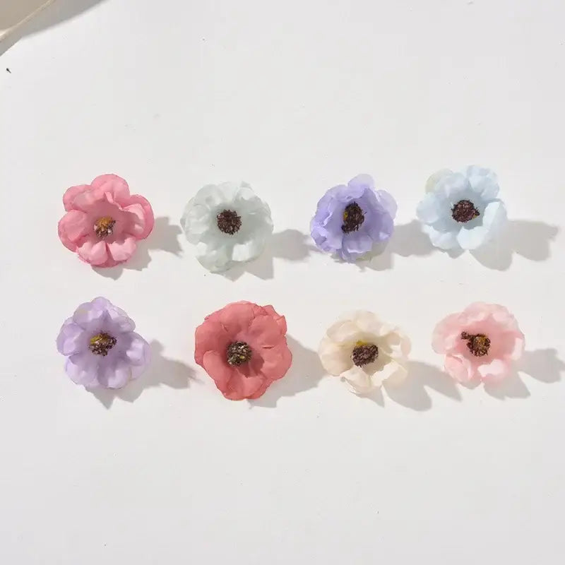 Pastel pink and lavender decorbites mini daisy artificial flowers with fabric petals and dark brown centers for wedding decor