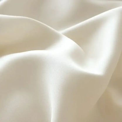Cream-colored satin fabric with smooth glossy folds in pastel pink cartoon embroidery cotton bedding set decorbites