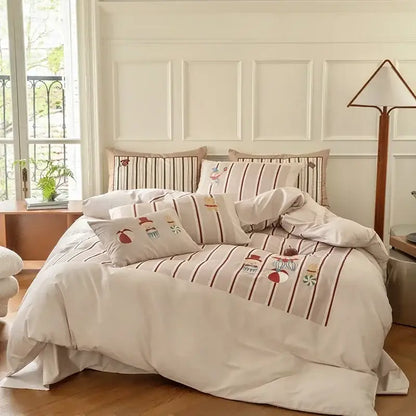Cream-colored decorbites cotton embroidered bedding set with vertical brown stripes and dessert-themed motifs