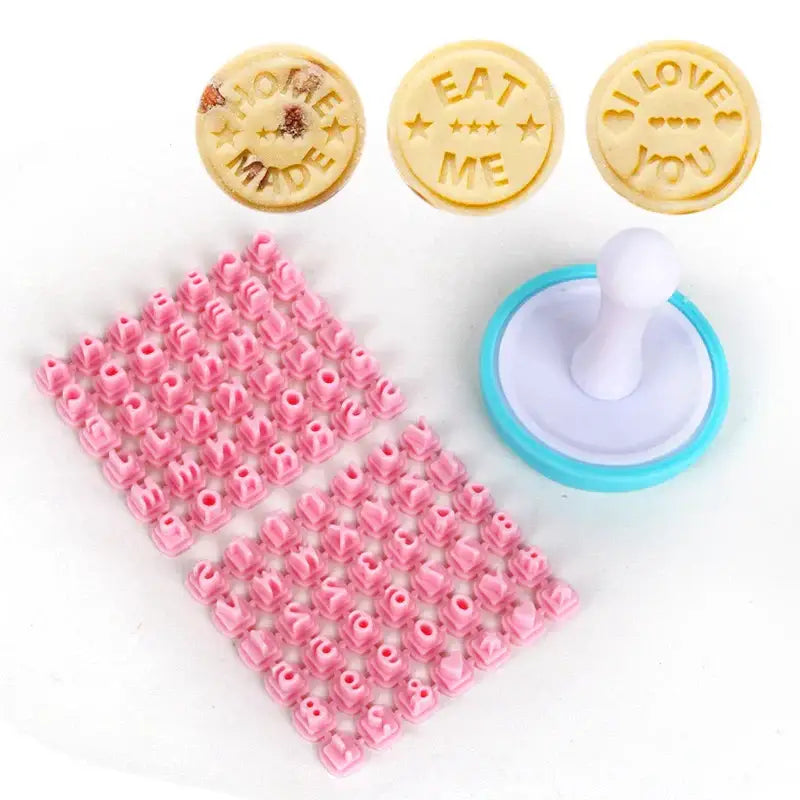 Set of three pastel pink and yellow decorbites cookie stamps with home made eat me i love you designs and a pink stencil sheet