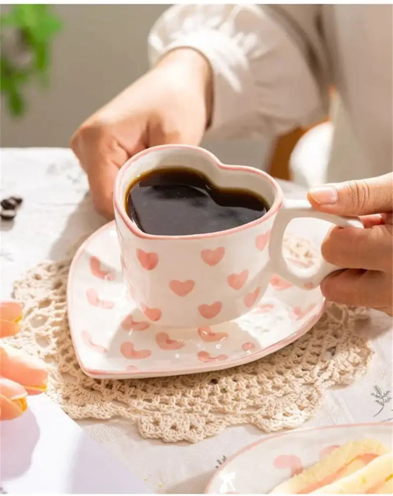 Pastel polka dot 250ml ceramic coffee cup with heart design filled with dark liquid for dining room use