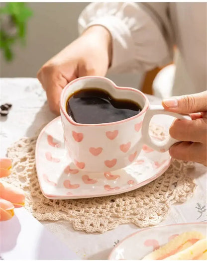 Pastel polka dot 250ml ceramic coffee cup with heart design filled with dark liquid for dining room use