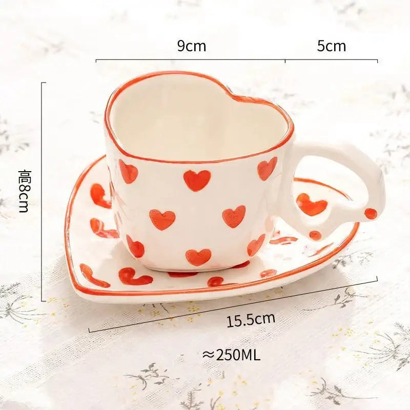 White ceramic heart-shaped 250ml coffee cup with red polka dots and matching saucer for dining room use