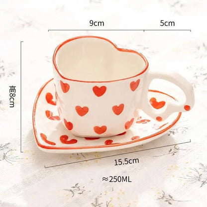 White ceramic heart-shaped 250ml coffee cup with red polka dots and matching saucer for dining room use