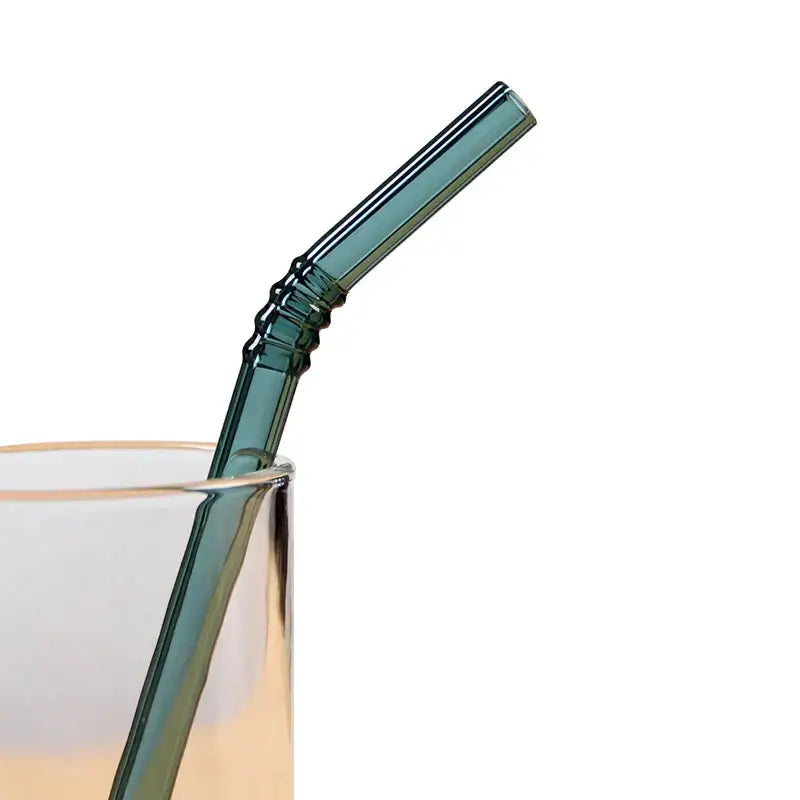 A sleek translucent teal decorbites glass straw with ribbed texture and gentle curve from pastel ridged glass straws set