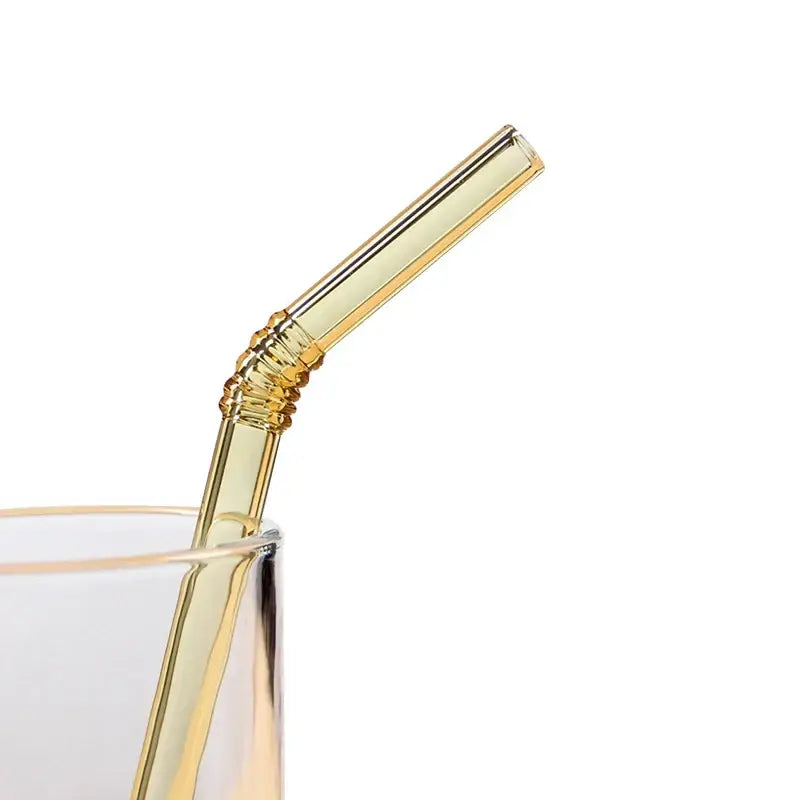 A translucent gold-tinted decorbites glass straw with a twisted ribbed section from a pastel ridged glass straws set