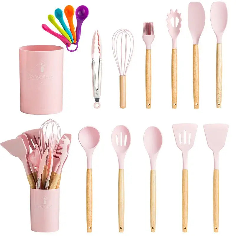 Pink silicone kitchen utensils set with wooden handles and matching ceramic storage cup for kitchen use