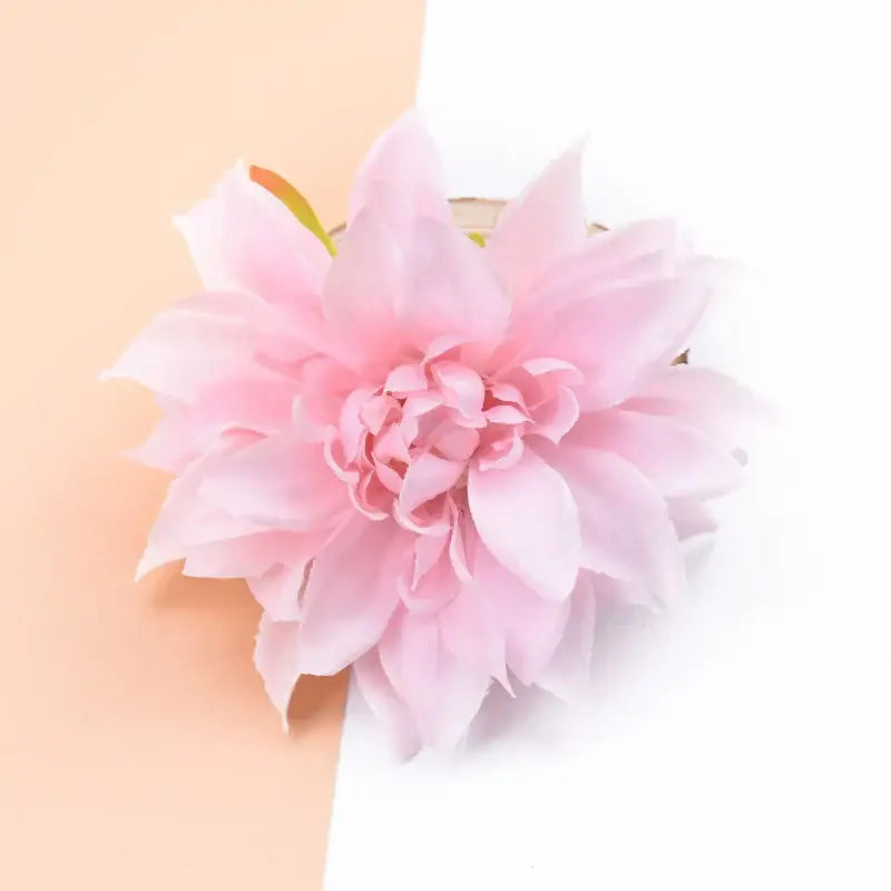 A delicate pink silk gerbera decorative flower with layered petals and fabric texture for wedding home decor
