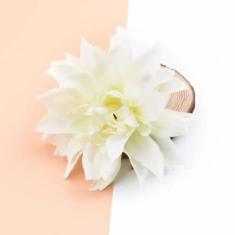 A delicate white silk gerbera decorative flower with layered petals for wedding and home decor