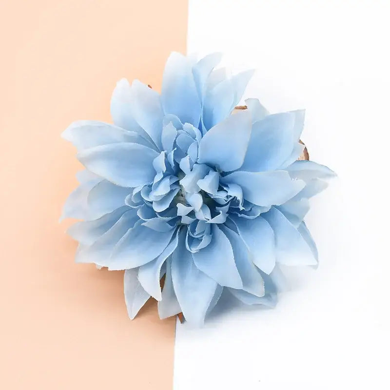 A delicate light blue silk gerbera decorative flower with layered soft petals for wedding home decor