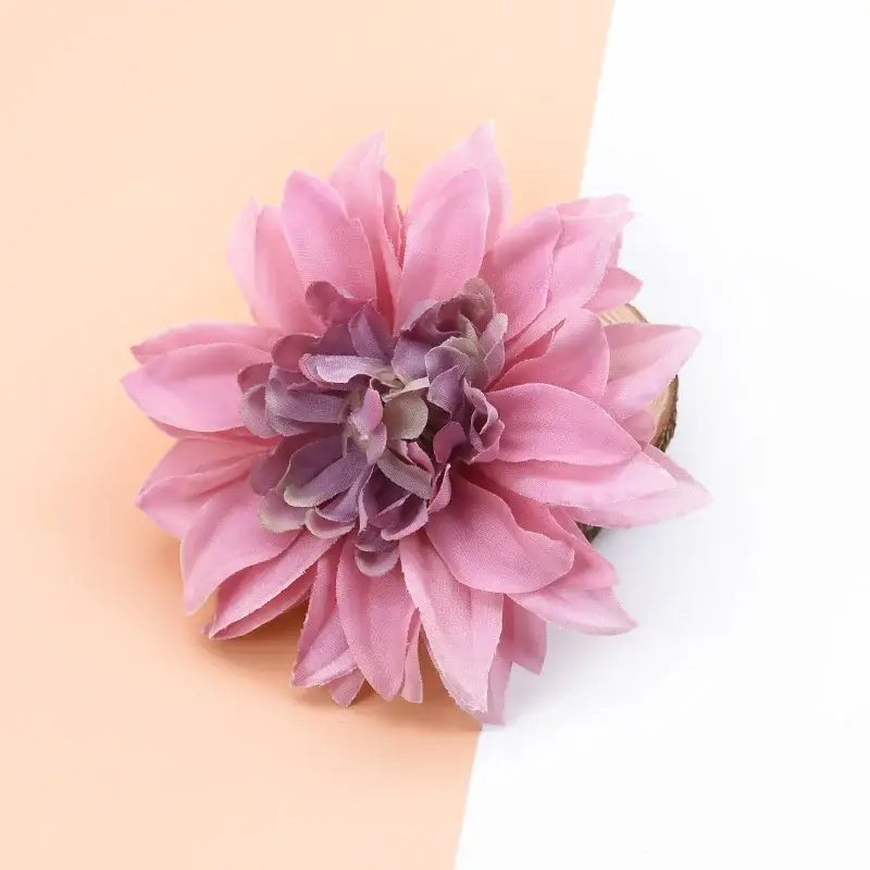 A delicate pink and purple silk gerbera decorative flower with layered fabric petals for wedding home decor