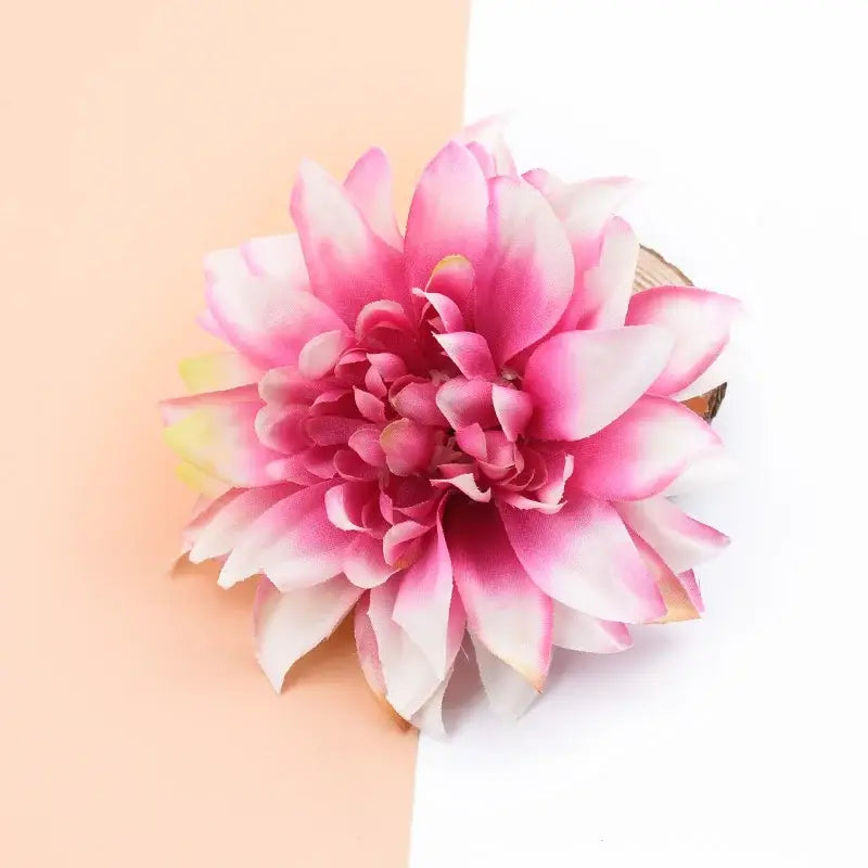 A vibrant pink and white silk gerbera flower hair accessory with layered petals for wedding and living room decor