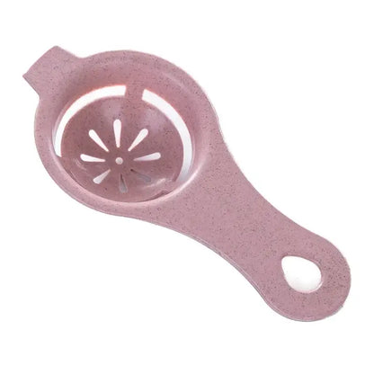 Pink speckled plastic egg white separator with star-shaped perforations and an oval handle cutout for kitchen use