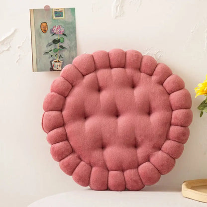 A plush round pink decorbites cookie biscuit cushion with tufted center and scalloped edge for living room decor
